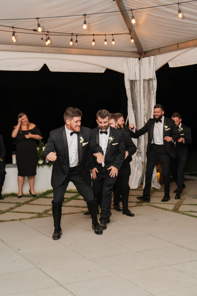 Groomsmen entrance at black tie wedding reception