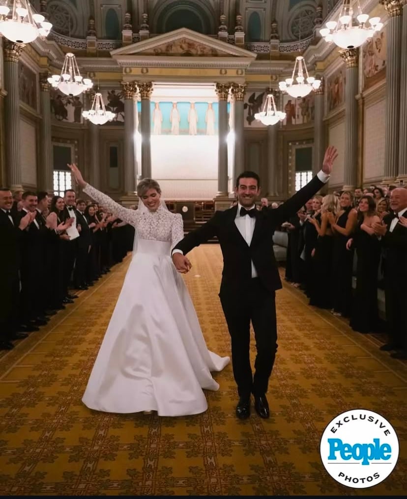 Bride and Groom Walking down the aisle with hands in the air