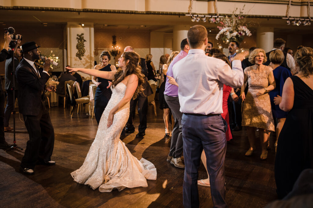 Bride and Wedding Band Singer on Dance Floor by Anastasia Romanova