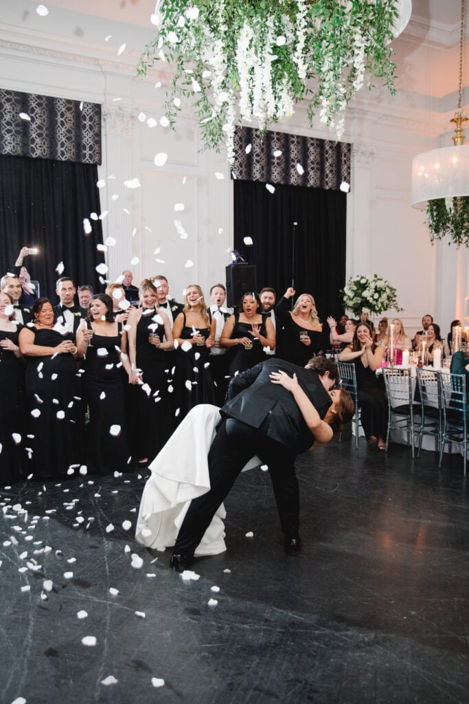 Bride and Groom first dance kiss showered in white rose petals